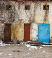 Three doors in an old dilapidated house.