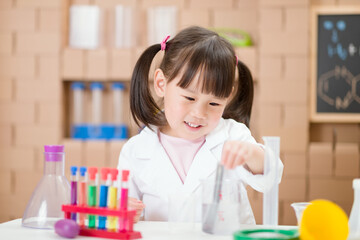 young girl plays  science experiment for home schooling