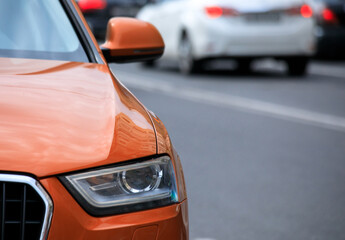 orange car in street - Powered by Adobe