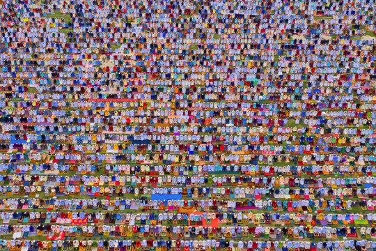 Aerial view of a vast crowd of people worshipping at Gore Shahid park in front of Eid Gah Minar religious site in Dinajpur, Rangpur, Bangladesh.