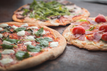 Home made pizza on dark wooden background