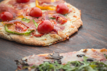 Home made pizza on dark wooden background