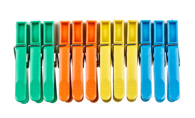 Colored plastic clothespins in a row isolated on white background