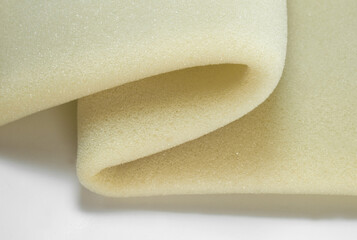 yellow sponge foam texture sheet with fold or bend effect on white background