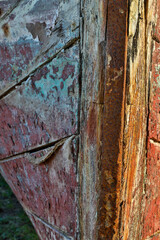 Old wooden fishing boat out of water, detail of paint. Crescent City, California.