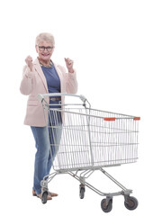 in full growth. a very happy old woman with a shopping cart