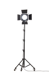 Flash light with barn doors on stand with wheels. Studio lighting equipment isolated on white background