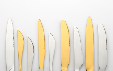 White and gold knives on a white background. cutlery on the table