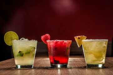 Mix fresh fruits cocktails on a wooden table. Mix fruits alcoholic cocktail