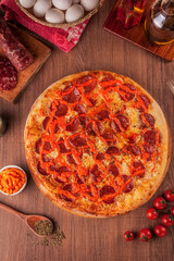 Pizza with salami, cream cheddar and mozzarella cheese - Traditional brazilian pizza de samale com queijo cheddar - Top view.