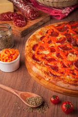 Pizza with salami, cream cheddar and mozzarella cheese - Traditional brazilian pizza de samale com queijo cheddar - Closeup.