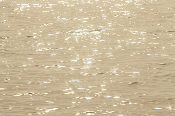 Detail of a sunlight reflecting in glittering sea. sparkler in water - background. sea water with...