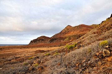 Landscape of a volcanic island in extremely warm sunset light.