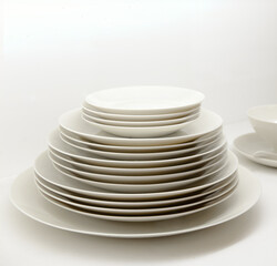 Stack of ivory colored plates against an ivory background.
