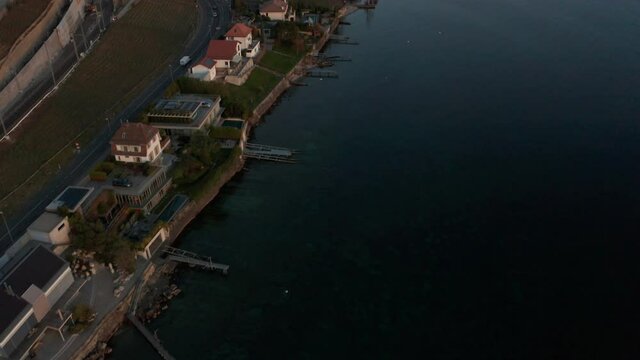 Aerial of lakeside houses, revealing beautiful large lake