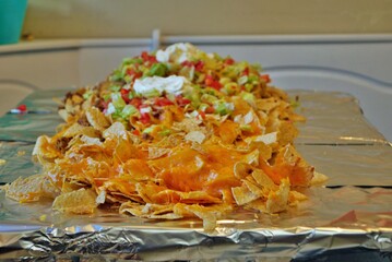 Nacho table kitchen table wrapped in aluminum foil and covered with nachos