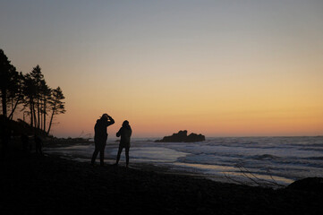 Couple enjoying the beach and sunset along the Washington Coast