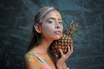 Fashion summer makeup. Abstract summer makeup. Pineapple fruit. Fashion girl with colorful powder...