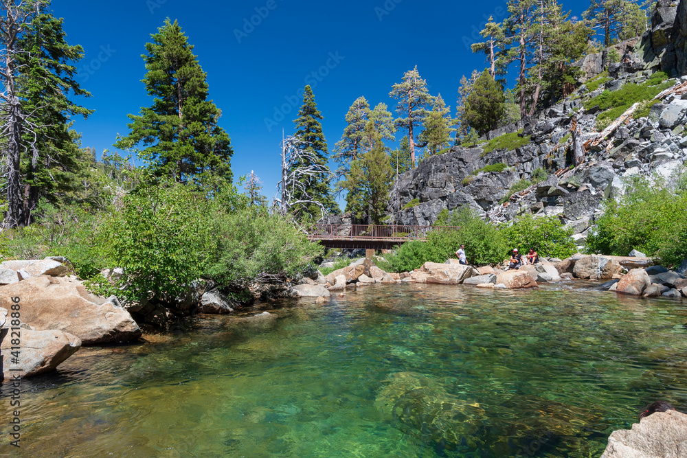 Sticker People sitting around the waters of Eagle Creek in Lake Tahoe, California.