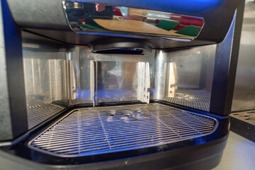 metal coffee machine for preparing a variety of delicious coffee in capsules with milk on the bar in the cafe