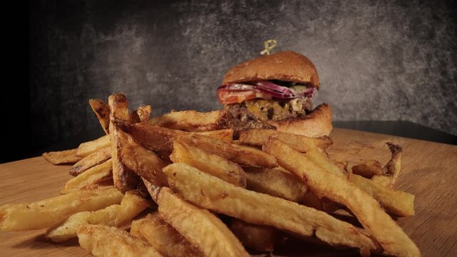Sliding shot over French fries to a burger - food photography