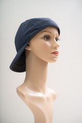 Fototapeta premium Mannequin wearing a cap in front of the white background