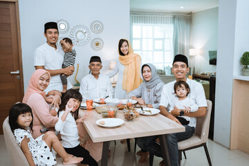 portrait of big asian muslim family on iftar dinner together smiling and looking at camera