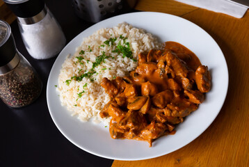 Traditional Czech Stroganoff pork tenderloin served with rice and greens..