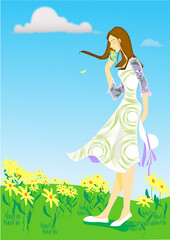 Fototapeta na wymiar A girl who smells flowers in a blooming spring field and her hair fluttered in the wind