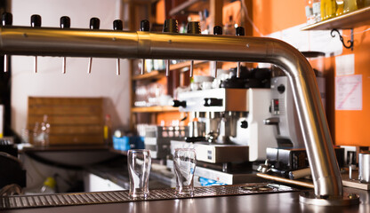 Image of modern beer bar with metal beer taps, nobody