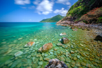 Fototapeta premium long exposure picture ,at Ao Hin Ngam bay rock beach, clear water beach, blue sky on summer , baan Chaloklum ,koh pha ngan ,Suratthani ,south of thailand