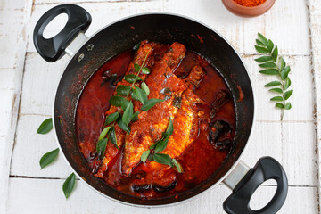 Spicy Mackerel fish curry gravy , cooking spicy Kerala fish curry , Goan red fish curry , Indian fish curry Bengali fish masala curry Kolkata, India Sri Lanka. Lankan food