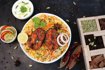 Fish biryani , Spicy and delicious Malabar biryani or Hyderabadi biryani, Dum Biriyani, pulao Kerala India Sri Lanka . basmati rice, herbs, raitha for Ramadan Kareem, Eid