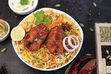 Fish biryani , Spicy and delicious Malabar biryani or Hyderabadi biryani, Dum Biriyani, pulao Kerala India Sri Lanka . basmati rice, herbs, raitha for Ramadan Kareem, Eid