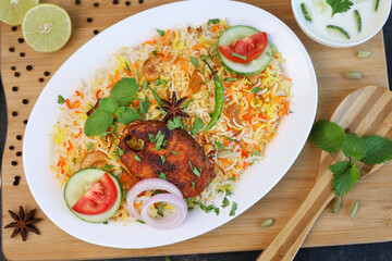 Fish biryani , Spicy and delicious Malabar biryani or Hyderabadi biryani, Dum Biriyani, pulao Kerala India Sri Lanka . basmati rice, herbs, raitha for Ramadan Kareem, Eid