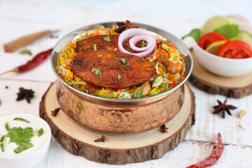 Fish biryani , Spicy and delicious Malabar biryani or Hyderabadi biryani, Dum Biriyani, pulao Kerala India Sri Lanka . basmati rice, herbs, raitha for Ramadan Kareem, Eid