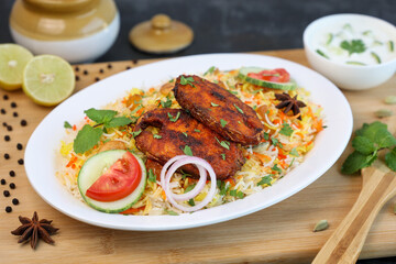 Fish biryani , Spicy and delicious Malabar biryani or Hyderabadi biryani, Dum Biriyani, pulao Kerala India Sri Lanka . basmati rice, herbs, raitha for Ramadan Kareem, Eid