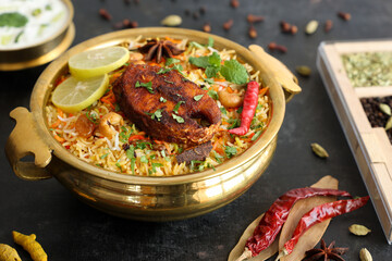 Fish biryani , Spicy and delicious Malabar biryani or Hyderabadi biryani, Dum Biriyani, pulao Kerala India Sri Lanka . basmati rice, herbs, raitha for Ramadan Kareem, Eid