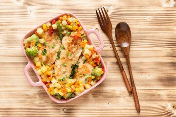 Fried chicken with vegetables corn and broccoli on a wooden background. Top view.