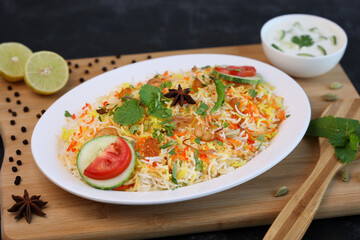 Vegetable biryani biriyani ,  Hyderabadi Shahi Pulao and raita Pilaf Basmati rice dish Indian spices Kerala India Sri Lanka Pakistan. Ghee rice, Lemon rice, boiled white rice