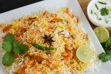 Vegetable biryani biriyani ,  Hyderabadi Shahi Pulao and raita Pilaf Basmati rice dish Indian spices Kerala India Sri Lanka Pakistan. Ghee rice, Lemon rice, boiled white rice
