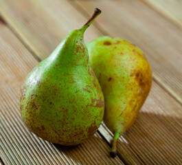 Juicy flavorful pears on natural wooden background..