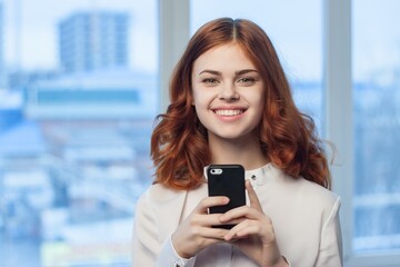 woman in shirt with phone in hand technology professional