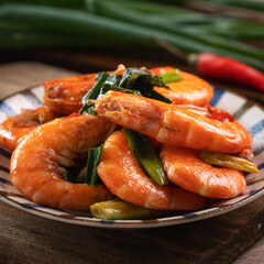 Delicious pan-fried shrimp on dark wooden table background.
