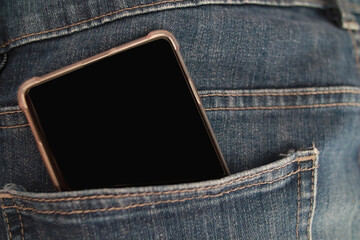 Mobile phone in blue denim jeans pant pocket, pocketing smartphone