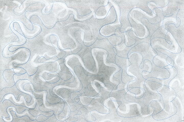 The texture of a drawn and shaded surface with maze-like winding paths.