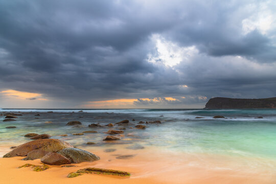 Sunrise at the seaside with rain clouds rolling in