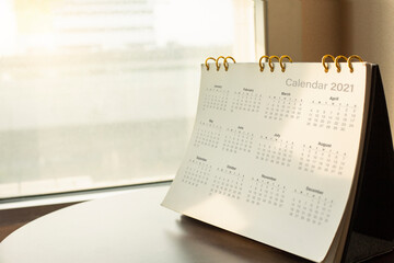 Desk calendar diary on hotel office table with year 2021 work place. Planning scheduling agenda,...