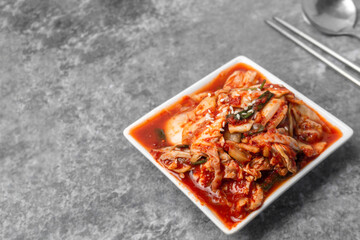 Korean side dish, Chinese cabbage kimchi on gray concrete table..