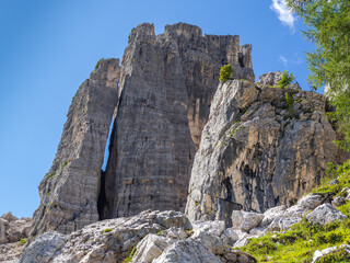 Fototapeta na wymiar Cortina, Italy. Amazing view of the climbers on the walls of the famous rocks of the 5 towers. Extreme climbing. Outdoors activities. Dolomites Unesco world heritage. Dolomites in Italy. summer time